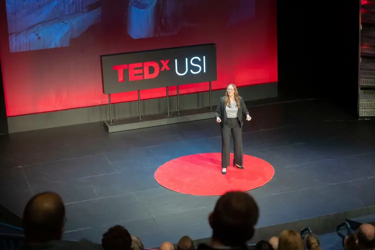 Photo of USI student on the TEDxUSI stage