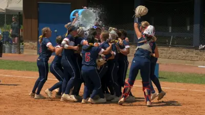 team celebrating a win dumping water cooler