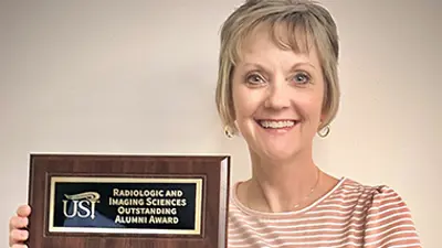 USI radiologic and imaging sciences alumna Susan Brumley with her Outstanding Alumni Award plaque