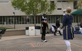Fencing Club members demonstrating a duel in full gear.