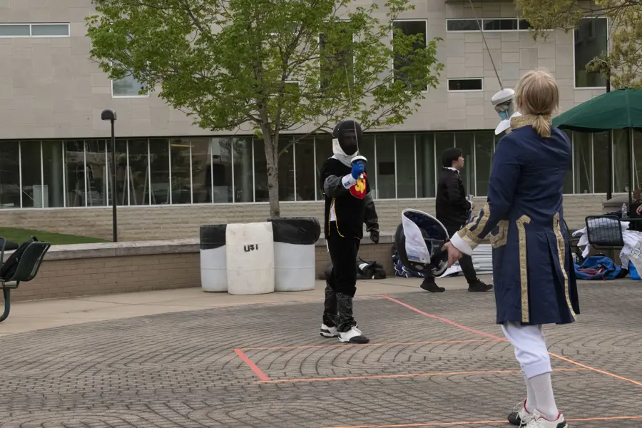 Fencing Club members demonstrating a duel in full gear.