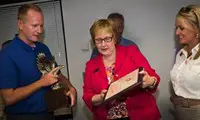 Mike Mikulski receiving trophy and certificate