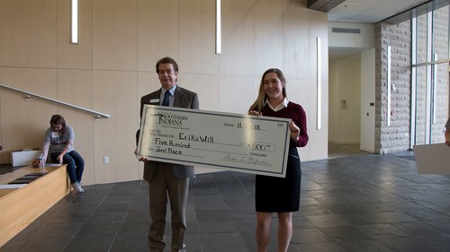 McGuire and Erika holding check