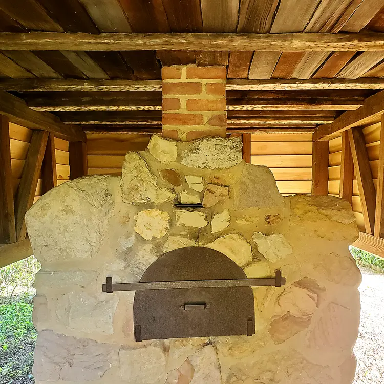 Historic Bake Oven in New Harmony constructed of large stones and a rounded iron door