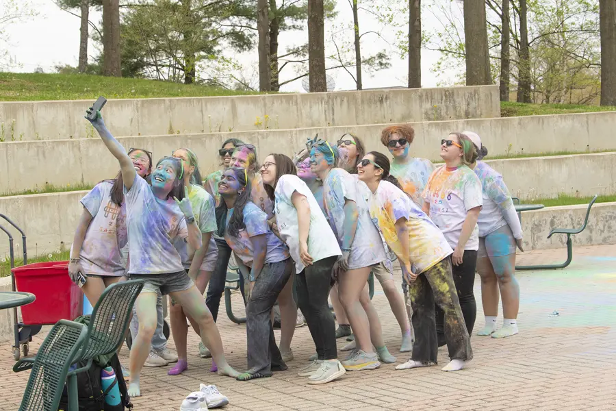 Covered in colorful cornflour dust, students take a selfie during USI's Holi celebration held in the spring. 
