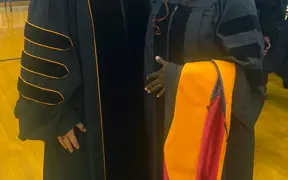 Jennifer Evans poses with student at graduation