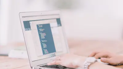 Open laptop with someone typing on the keyboard