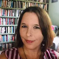 Amie Whittemore standing by a pond in the woods