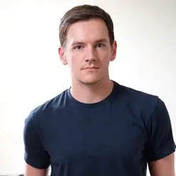 Amie Whittemore standing by a pond in the woods