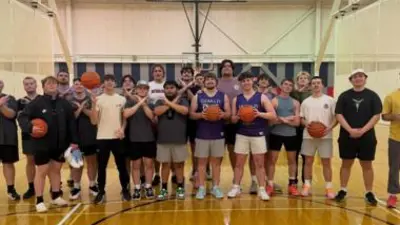 group of men posing for a picture in a gym