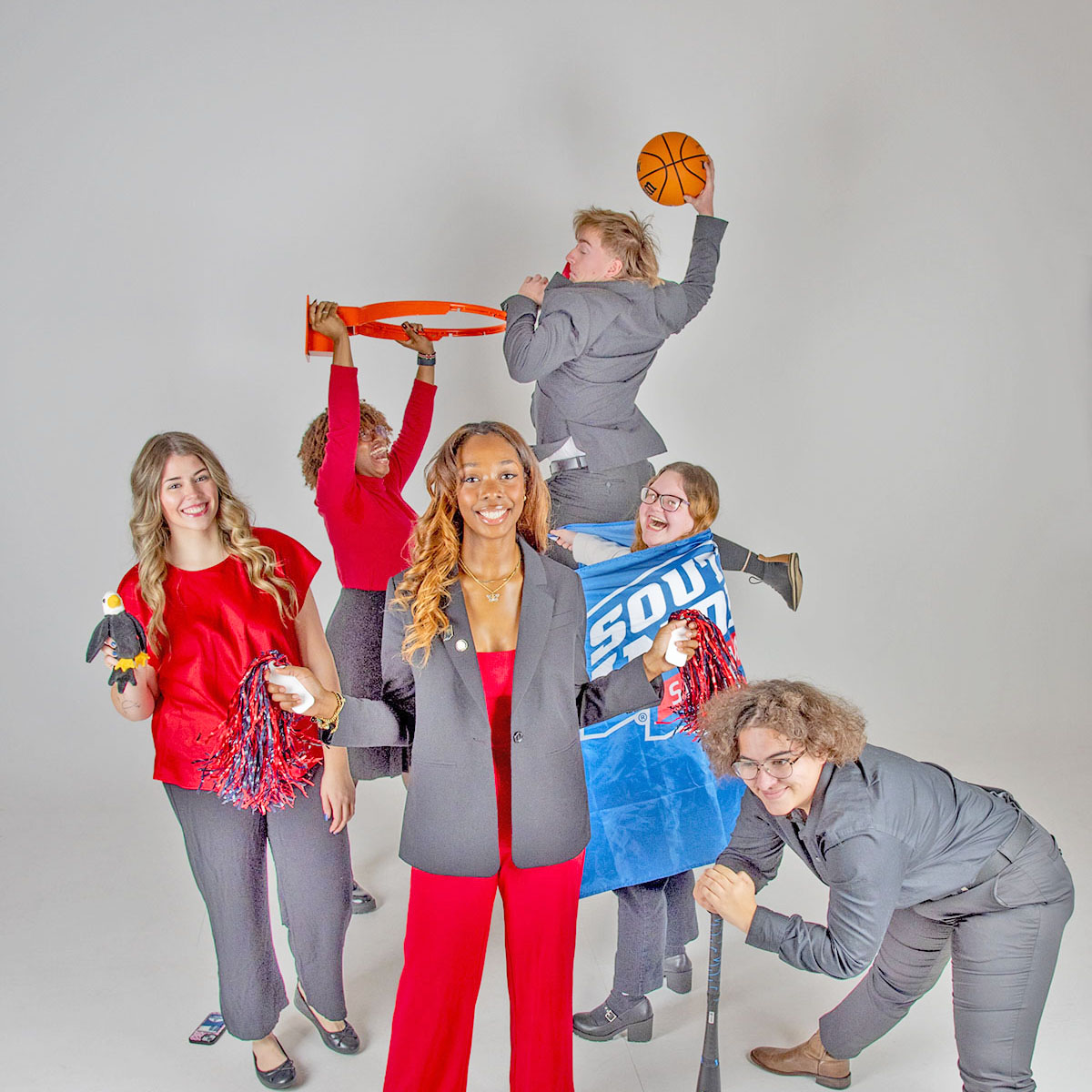The executive committee of Student Government Association play with athletic props for a fun group photo.
