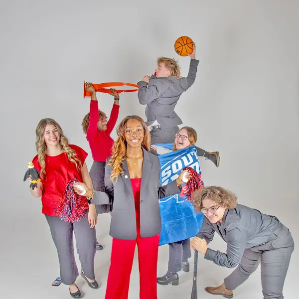 The executive committee of Student Government Association play with athletic props for a fun group photo.