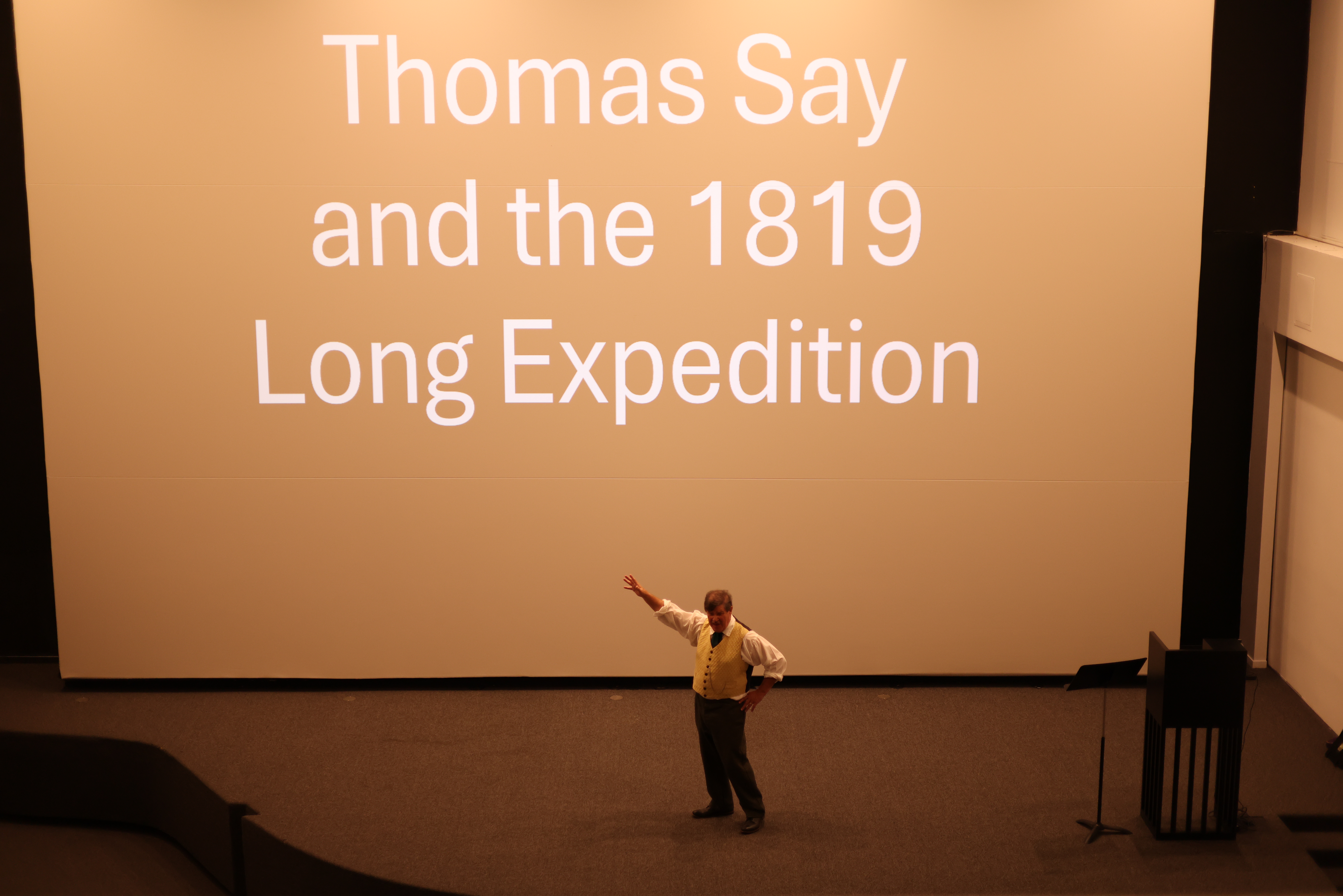 Presentation slide reading “Thomas Say and the 1819 Long Expedition” projected in a theater.