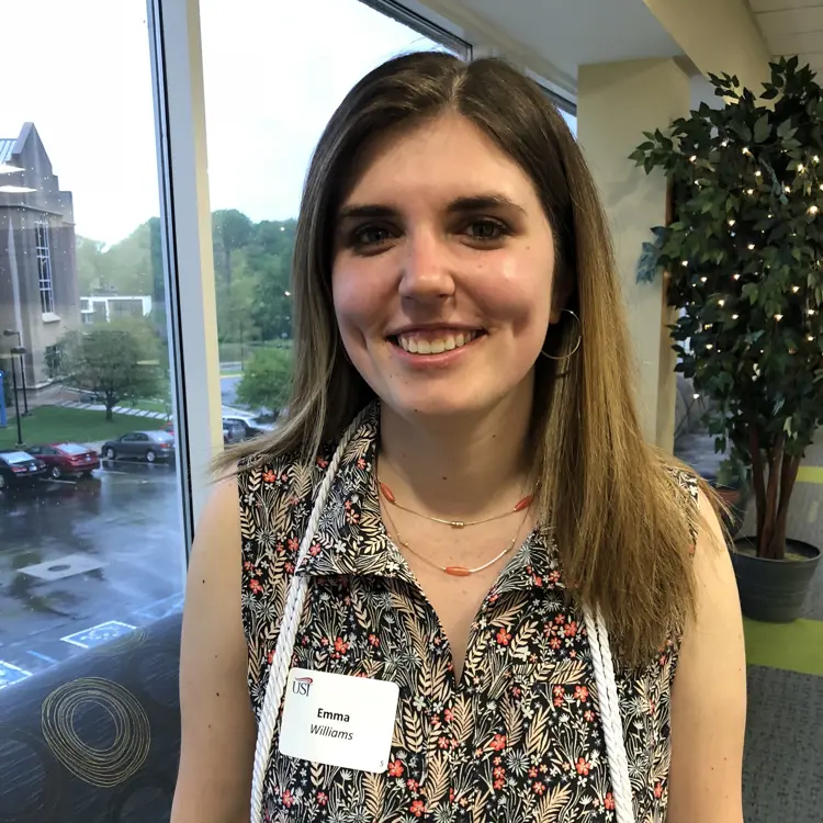 Casual portrait of pre-occupational therapy student Emma Williams wearing a nametag