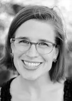 Amie Whittemore standing by a pond in the woods