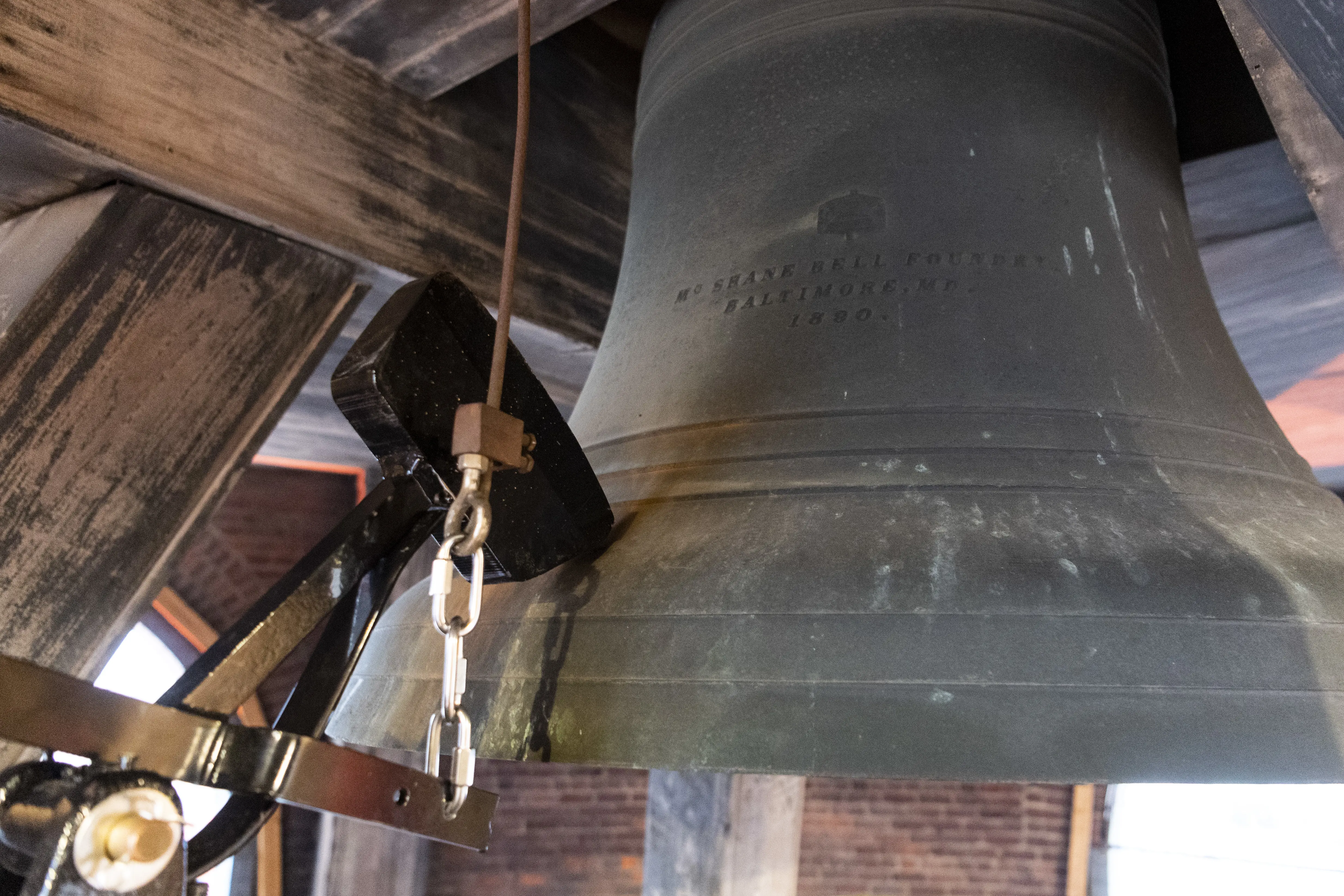 Close up view of the Old Courthouse bell and strike hammer mechanism.