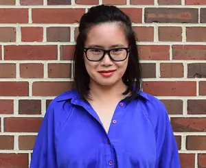 Amie Whittemore standing by a pond in the woods