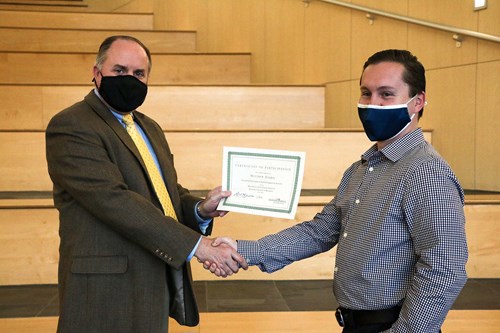 Thomas presenting certificate to Matthew