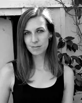 Amie Whittemore standing by a pond in the woods