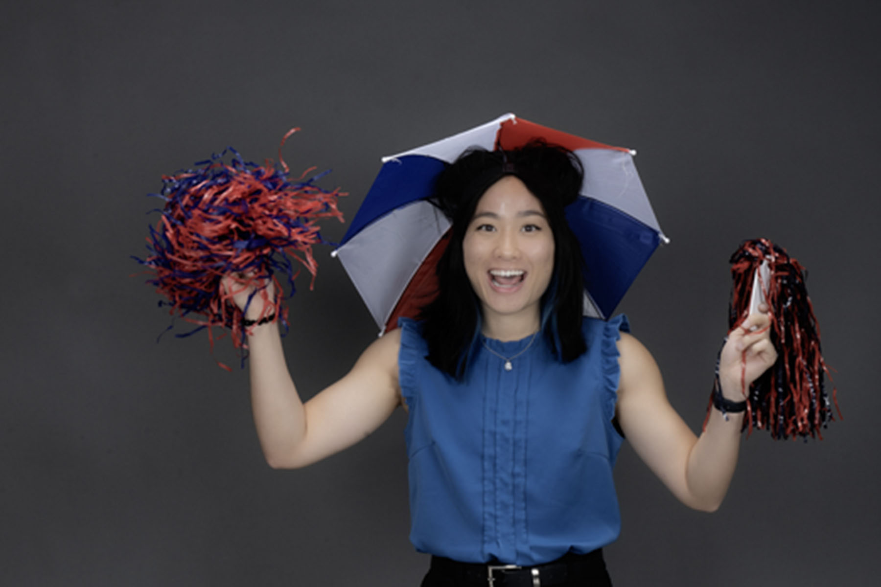 A member of the homecoming court, who always wears an umbrella hat and dancing on University Boulevard at new student orientation wears her umbrella hat and shakes pom poms.