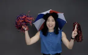 A member of the homecoming court, who always wears an umbrella hat and dancing on University Boulevard at new student orientation wears her umbrella hat and shakes pom poms.
