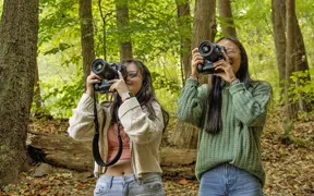 Photography students take photos of nature on the USI Trails. 