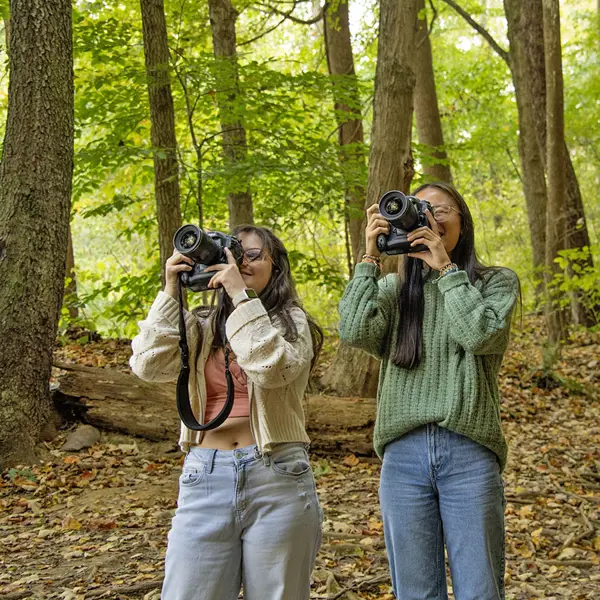 Photography students take photos of nature on the USI Trails. 
