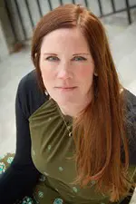 Amie Whittemore standing by a pond in the woods