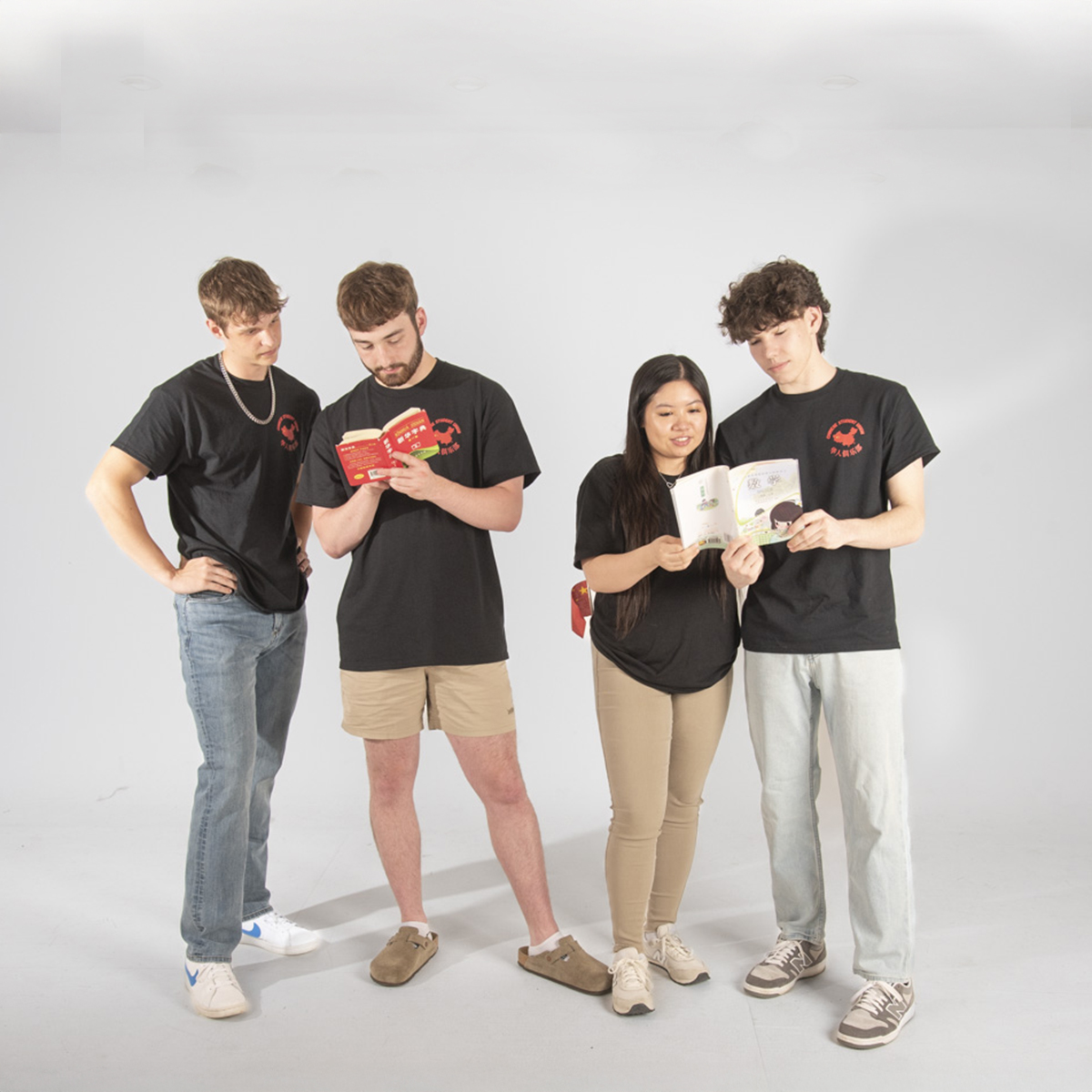 Members of the Chinese Student Union pretend to look at Chinese children's books for their group photo.