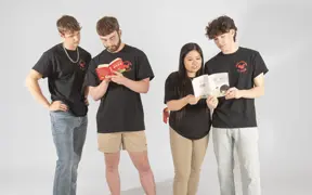 Members of the Chinese Student Union pretend to look at Chinese children's books for their group photo.