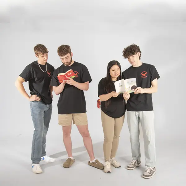 Members of the Chinese Student Union pretend to look at Chinese children's books for their group photo.