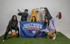 Members of Activities Programming Board play with the athletic props for their group photo.