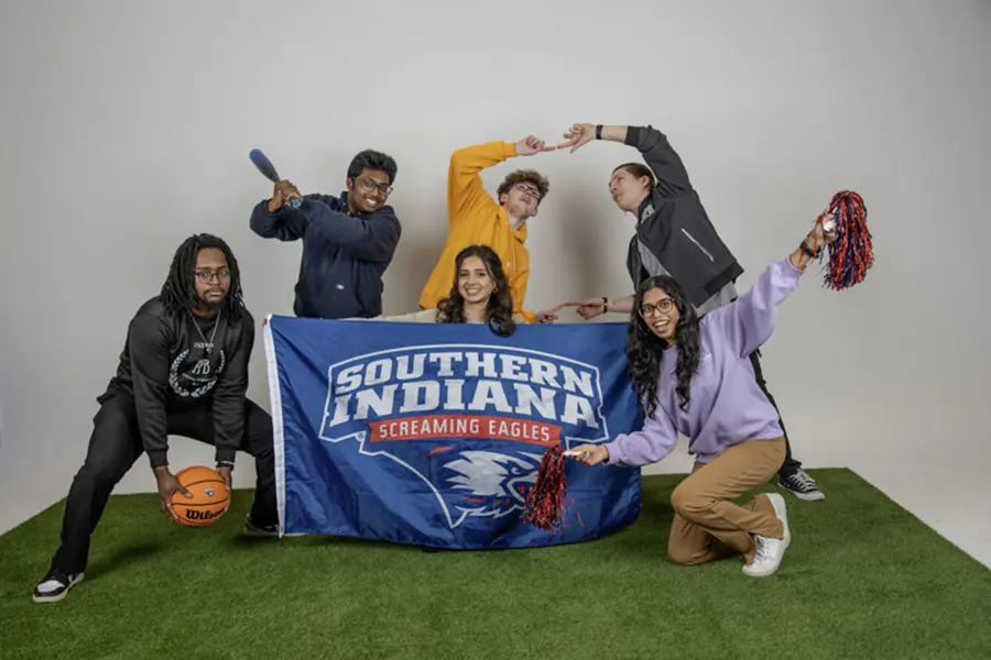 Members of Activities Programming Board play with the athletic props for their group photo.