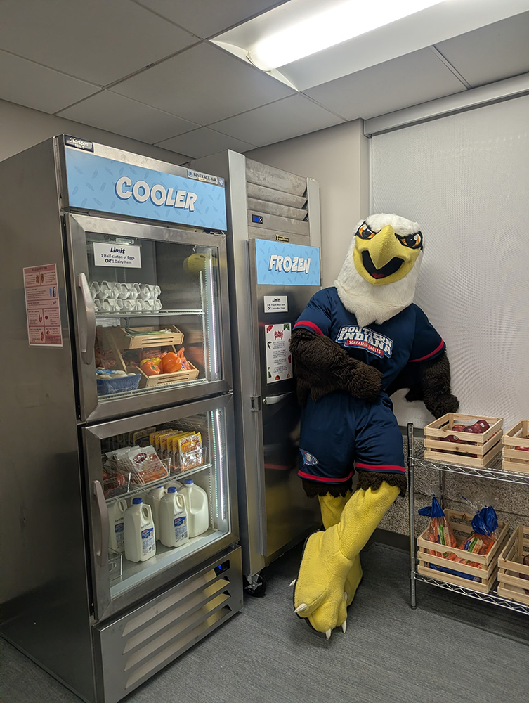 Archie standing by the cooler and freezer inside the pantry
