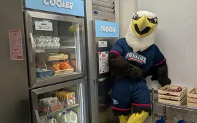 Archie standing by the cooler and freezer inside the pantry