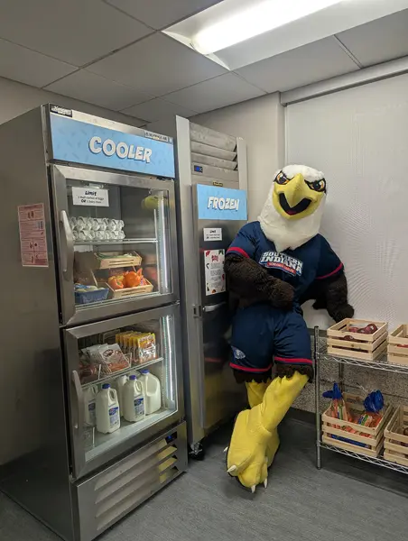 Archie standing by the cooler and freezer inside the pantry