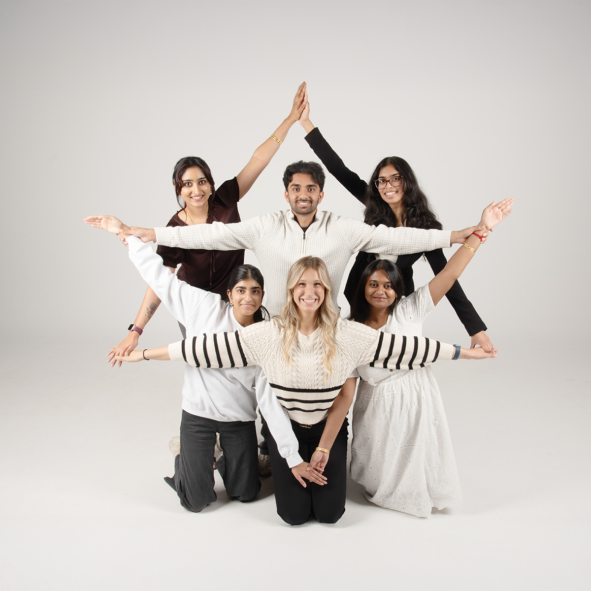 The Executive Committee of the South Asian Student Union strike a fun post in the photo studio.