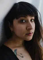 Amie Whittemore standing by a pond in the woods