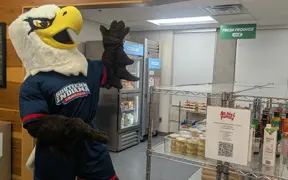 Archie pointing to the "Archie's Pantry" sign