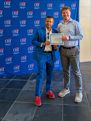 Dean handing Lucas a certificate