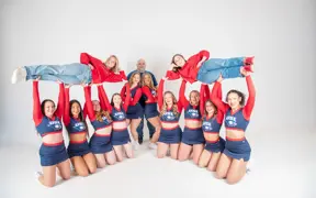 The USI cheer team lift their two long-time coaches in the air. 