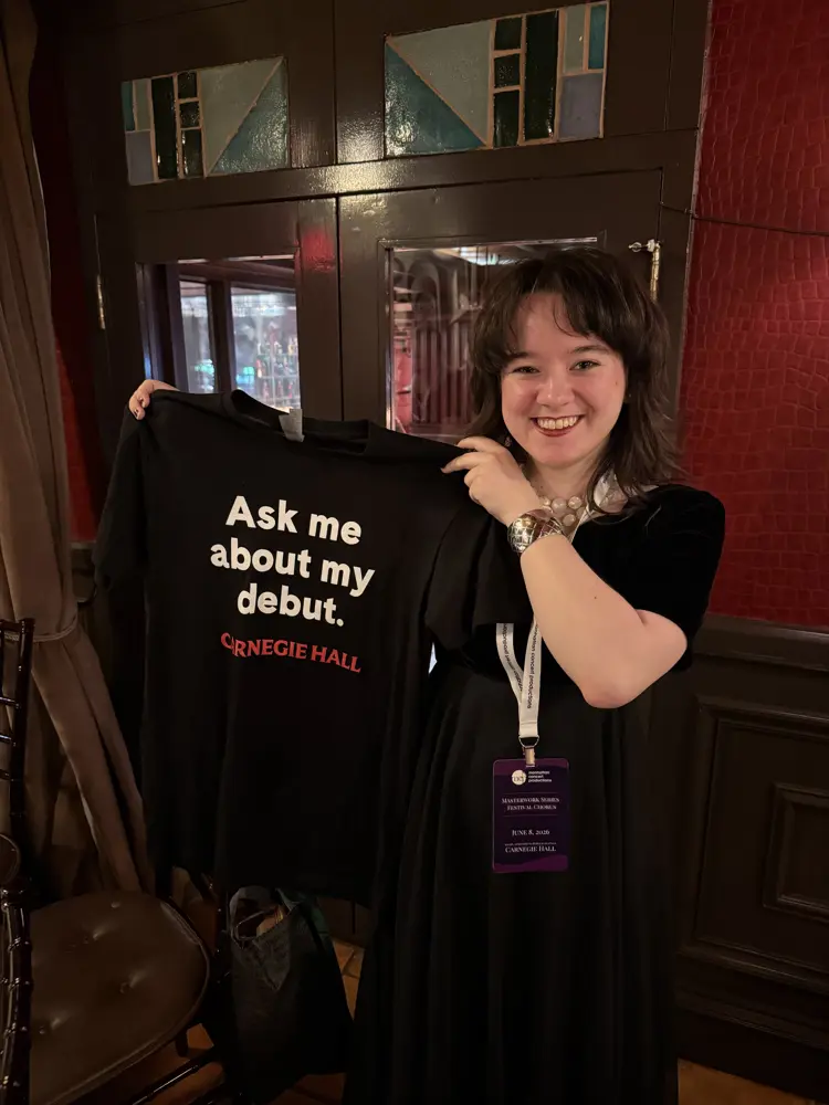 Morgan Stauter holding a tee shirt
