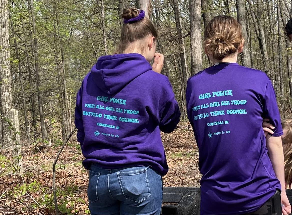 A Girl Scout/Scouting Troop pause to admire their work after installing a bench on the Bent Twig Trail.