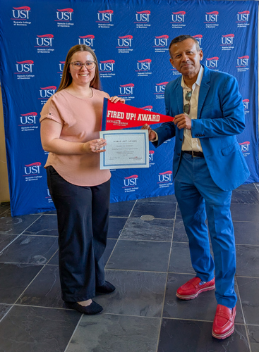 Dean handing Jasmyne a certificate and pennant