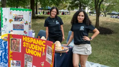 two students at a table promoting their organization 