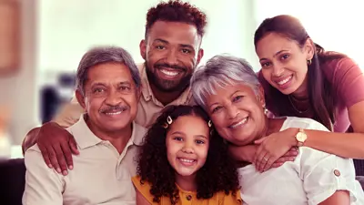 Group of smiling adults with a child