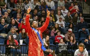 Student reacting to being announced as winner of Homecoming King in Liberty Arena