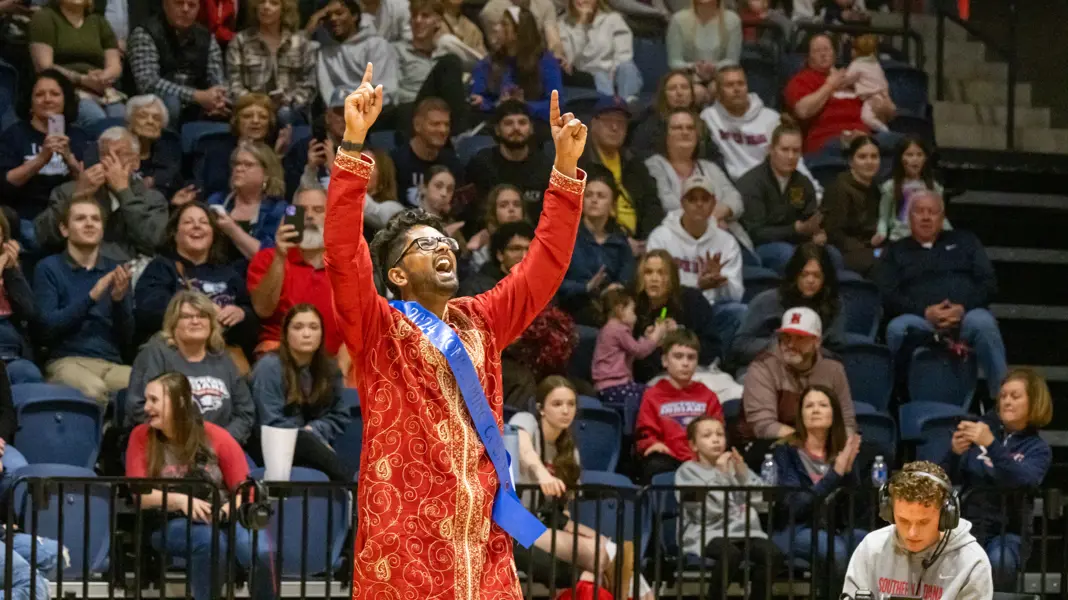 Student reacting to being announced as winner of Homecoming King in Liberty Arena