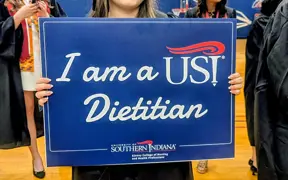 Student holding sign that says "I am a USI Dietitian"