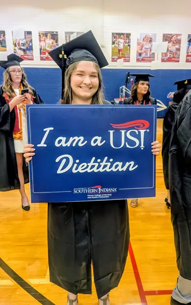 Student holding sign that says "I am a USI Dietitian"